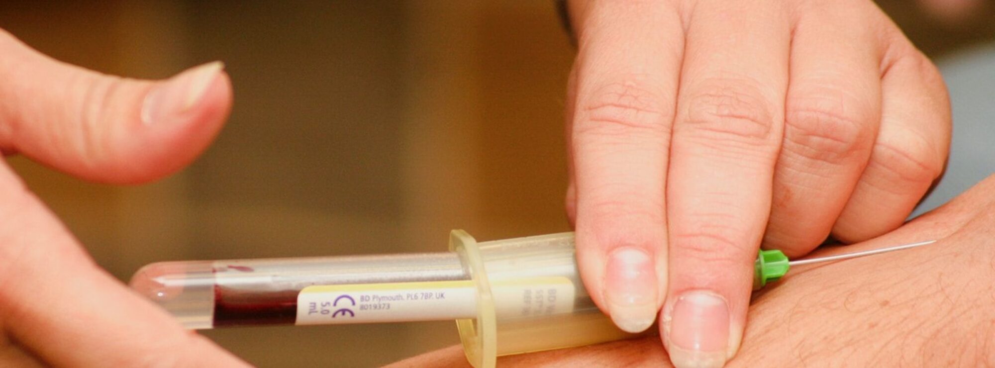 person injecting syringe